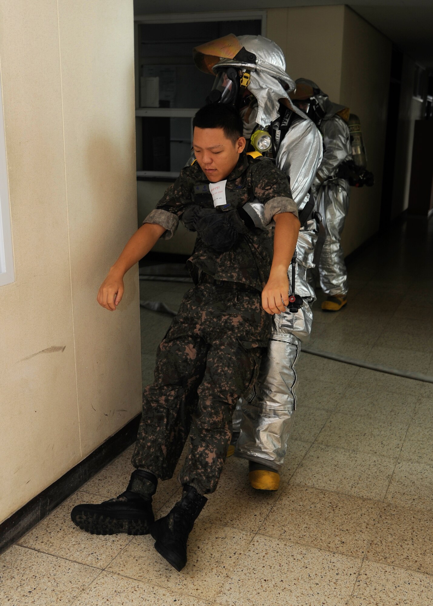 KUNSAN AIR BASE, Republic of Korea – Staff Sgt. Bryan Bereza, 8th Civil Engineer Squadron fire department company officer, rescues an injured Republic of Korea airman during exercise Beverly Midnight 13-3, Aug. 7, 2013. Bereza rescued the airman during a simulated mass casualty exercise administered by the base’s exercise evaluation team. (U.S. Air Force photo by Staff Sgt. Jessica Haas/Released)