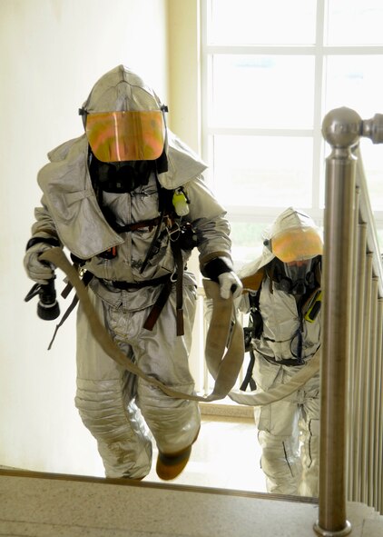 KUNSAN AIR BASE, Republic of Korea – Staff Sgt. Bryan Bereza, 8th Civil Engineer Squadron fire department company officer, and Senior Airman Brandon Shaw, 8th CES fire department crew member, make their way up to the third floor of a Republic of Korea air force dormitory during exercise Beverly Midnight 13-3, Aug. 7, 2013. The Fire Dogs  searched every room for injured airmen while fighting a simulated fire on the third floor. (U.S. Air Force photo by Staff Sgt. Jessica Haas/Released)