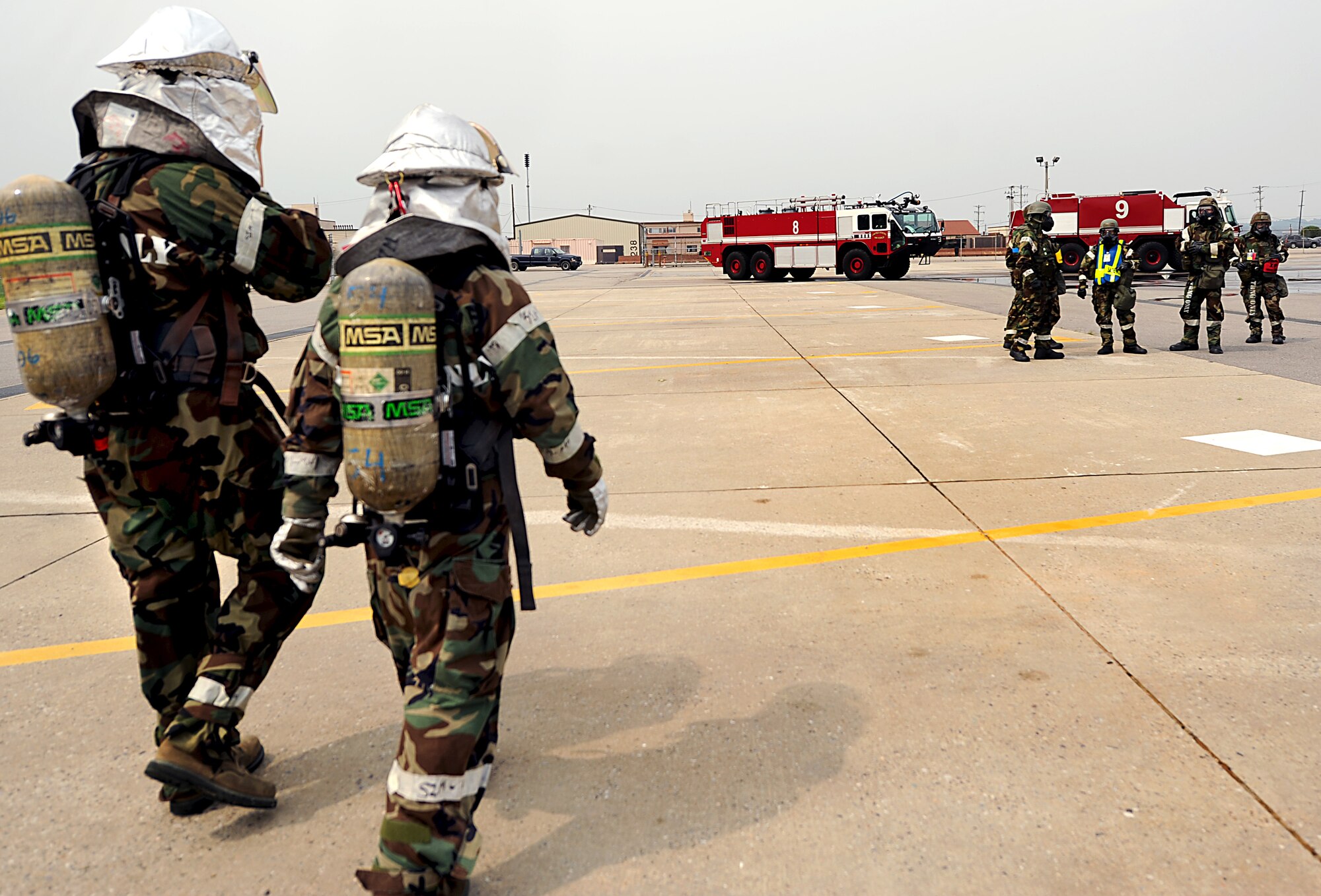 Fire fighters from the 51st Civil Engineer Squadron respond to a simulated fire as members of the Exercise Evaluation Team and 51st Fighter Wing Safety evaluate their procedures during Operational Readiness Exercise Beverly Midnight 13-03 at Osan Air Base, Republic of Korea, Aug. 7, 2013. Throughout the week-long exercise Airmen throughout the base will undergo several different scenarios like this that will test their ability to defend the base and conduct daily operations during a heightened state of readiness. (U.S. Air Force photo/Staff Sgt. Sara Csurilla)