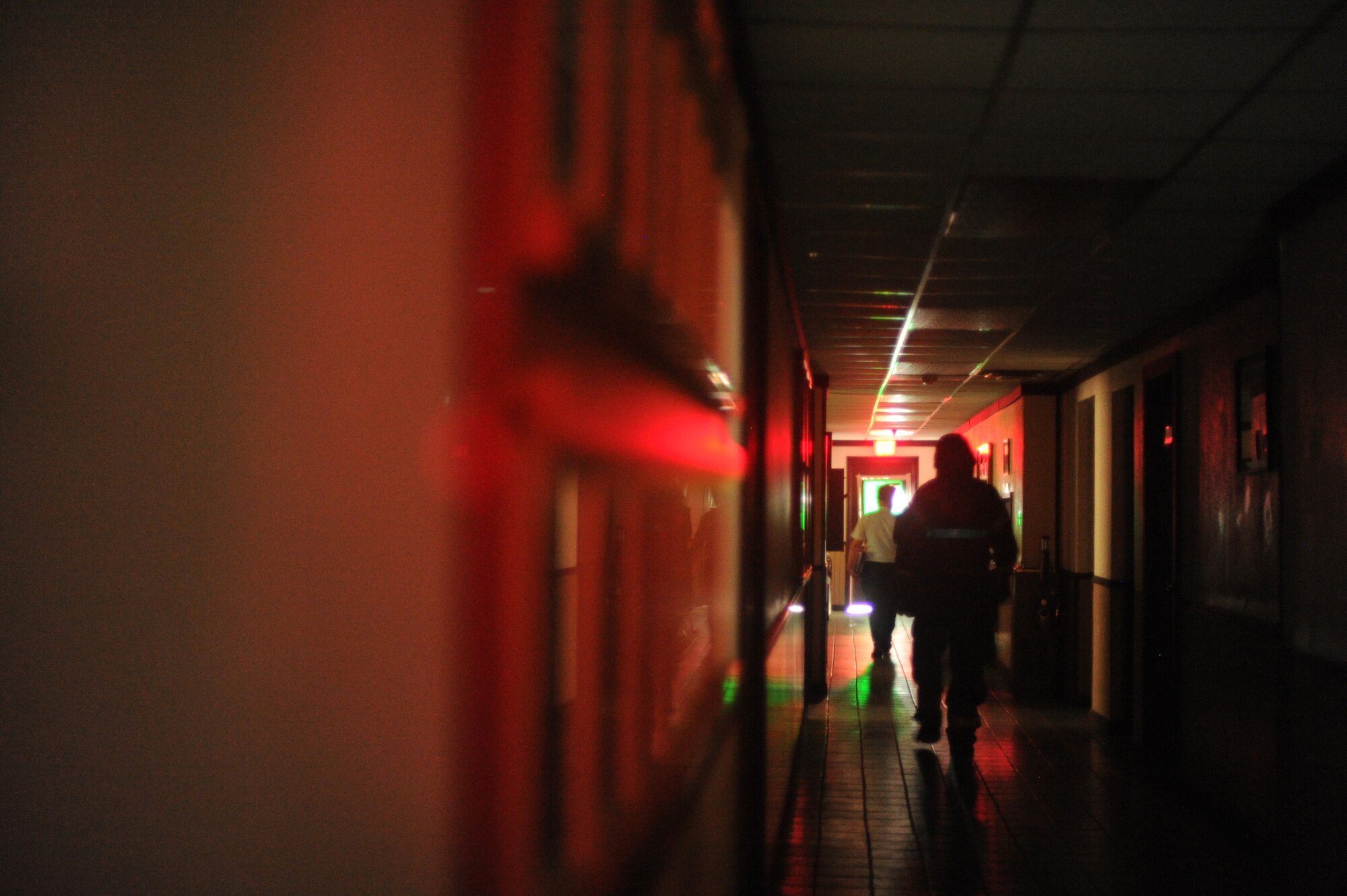 Members of the 51st Fighter Wing Exercise Evaluation Team and 51st Fighter Wing Safety office clear a building before fire fighters from the 51st Civil Engineer Squadron respond to a simulated fire during Operational Readiness Exercise Beverly Midnight 13-03 at Osan Air Base, Republic of Korea, Aug. 7, 2013. During the ORE, Airmen don Mission Oriented Protective Posture (MOPP) gear following an attack when contamination is present or suspected or when the highest level of protection is required. (U.S. Air Force photo/Staff Sgt. Sara Csurilla)