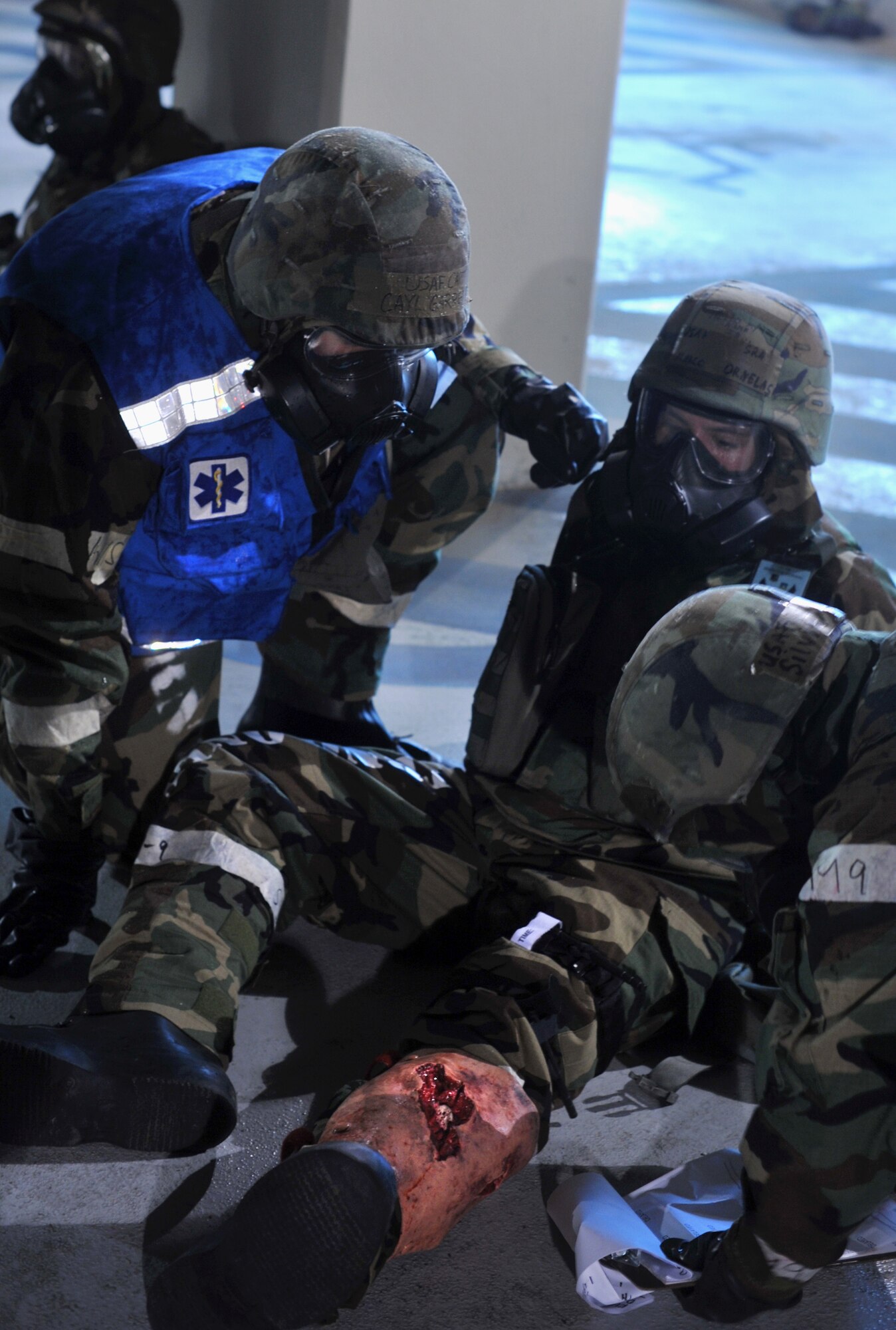 36th Fighter Squadron flight surgeon, Capt. Cayl Garrett, left, and Senior Airman Silvia Headrick, 51st Aerospace Medicine Squadron flight medicine administrative technician, right, analyze the wound severity of simulated victim after a mass casualty scenario during Operational Readiness Exercise Beverly Midnight 13-03 at Osan Air Base, Republic of Korea, Aug. 6, 2013. Role players important during OREs to provide a more realistic scenario for Osan Airmen to practice self-aid buddy care during wartime conditions. (U.S. Air Force photo/Kristina Overton) 