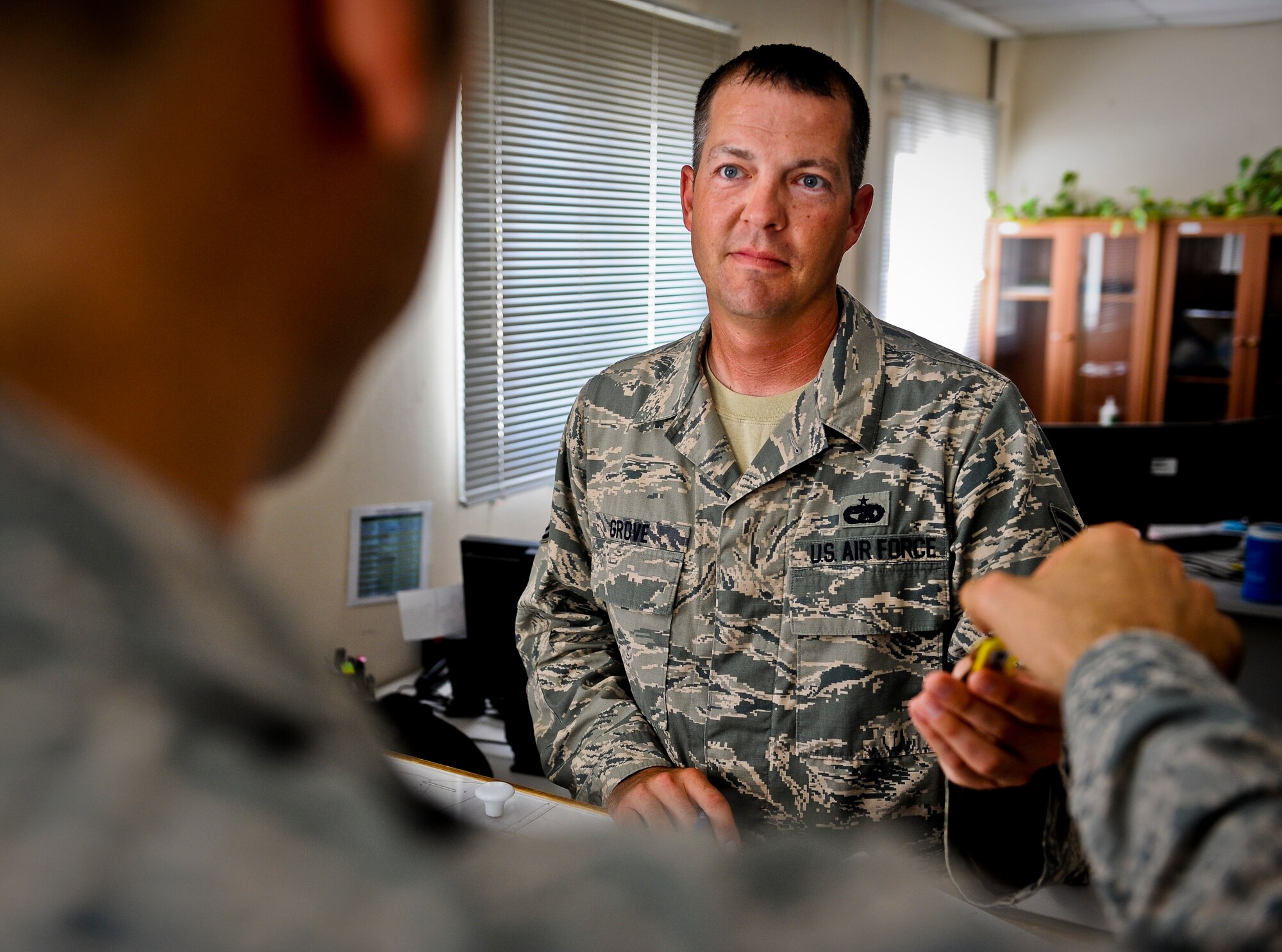 Tech. Sgt. Jonathan Grove accepts a customer?s keys as he enters the vehicle into their system for service at the 379th Air Expeditionary Wing in Southwest Asia, July 31, 2013. Grove is the 379th Expeditionary Logistics Readiness Squadron lease vehicle management NCO in charge deployed from Holloman Air Force Base, N.M. (U.S. Air Force photo/Senior Airman Benjamin Stratton)