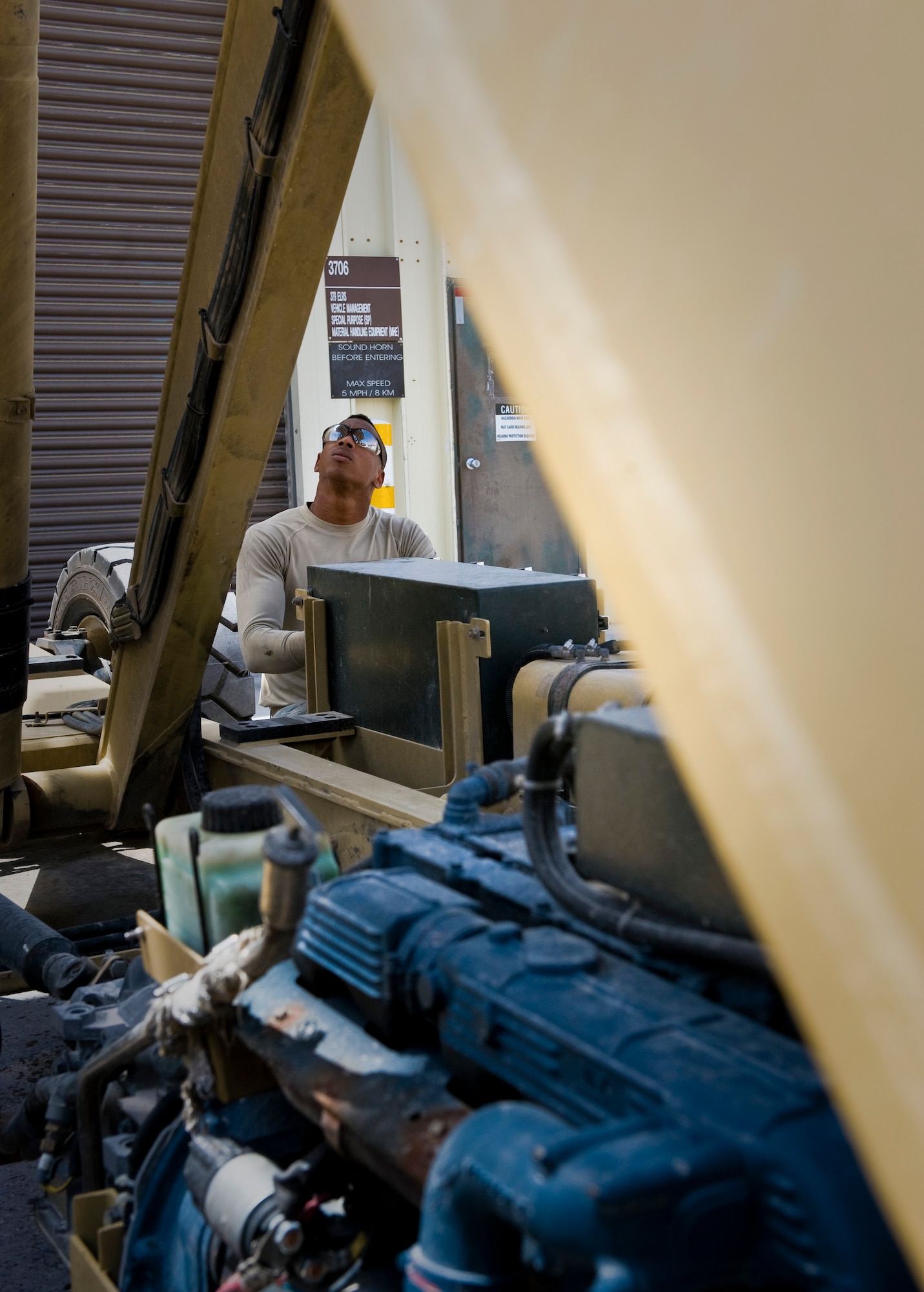 Senior Airman Maurice Kelly performs routine maintenance on a Tunner 60K aircraft cargo loader at the 379th Air Expeditionary Wing in Southwest Asia, July 31, 2013. Kelly is a 379th Expeditionary Logistics Readiness Squadron material handling and equipment mechanic deployed from Seymour Johnson Air Force Base, N.C. (U.S. Air Force photo/Senior Airman Benjamin Stratton)
