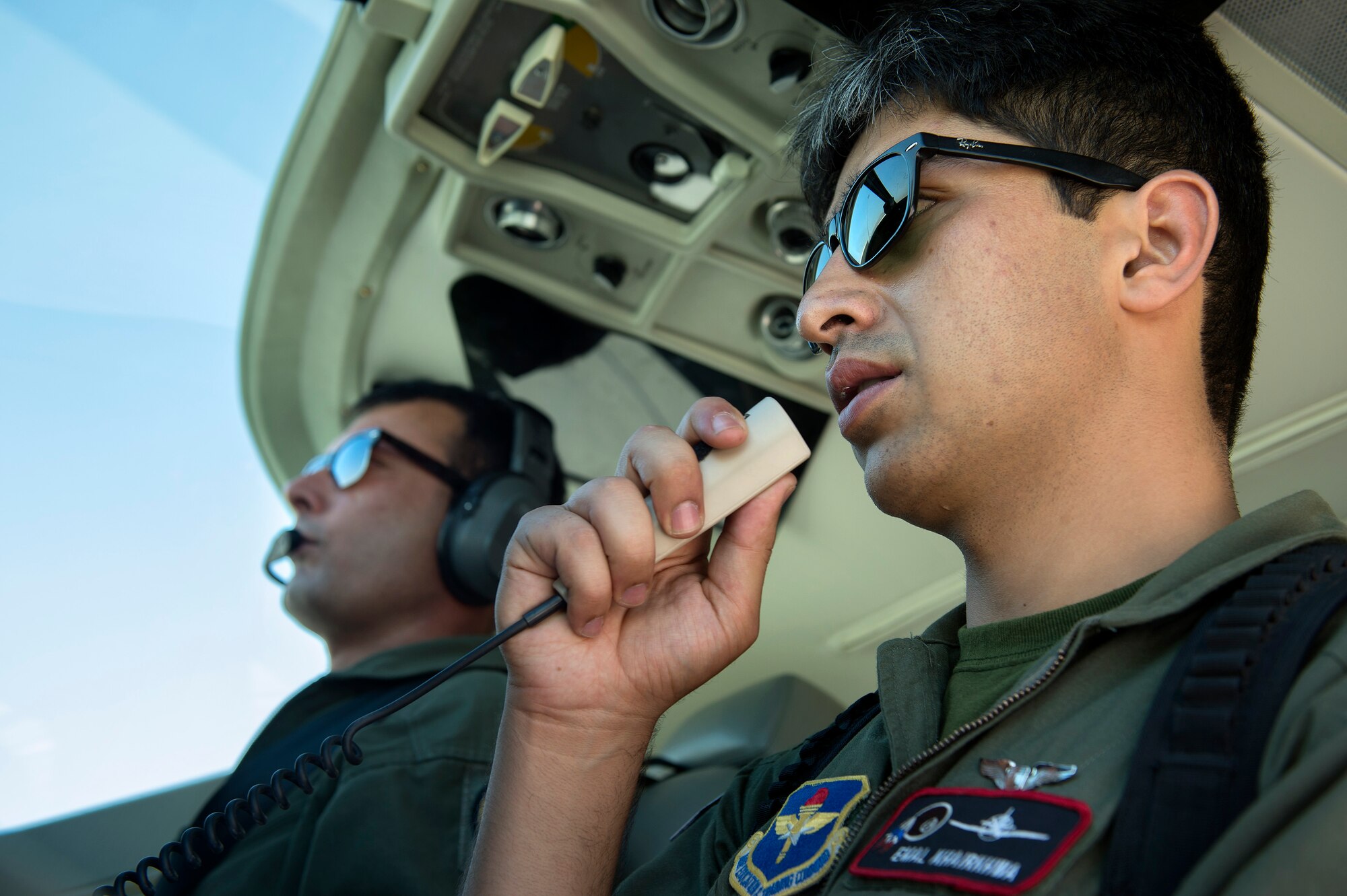 Afghan Air Force 1st Lt. Emal Khairkhwa, 373rd Fixed Wing Squadron pilot, communicates with the control tower as AAF 1st Lt. Mohammad Tawfiq Safi, copilot, looks on before a Cessna 208 mission out of Kabul International Airport, Afghanistan, Aug 6, 2013. This mission marked the first all AAF fixed wing combat mission flown from the Kabul Air Wing. (U.S. Air Force Photo/Master Sgt. Ben Bloker)
