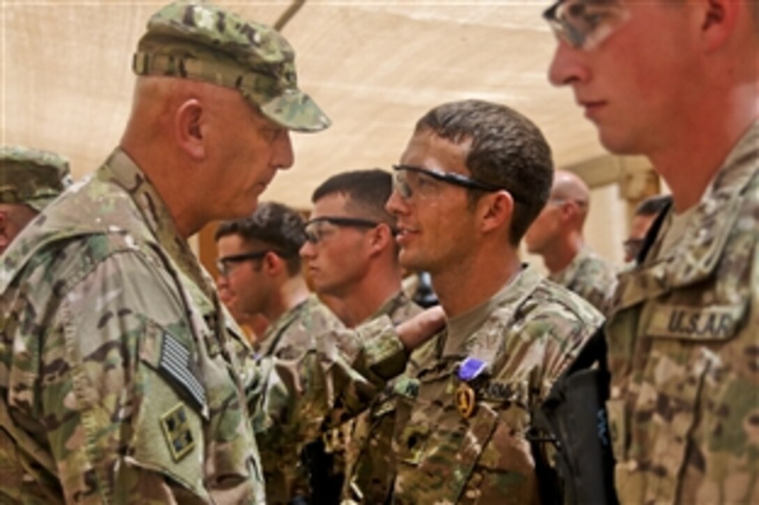 U.S. Army Chief of Staff Gen. Ray Odierno presents the Purple Heart to U.S. Army Spc. Thomas Wirthlin during a ceremony on Forward Operating Base Azizullah, Afghanistan, Aug. 7, 2013.