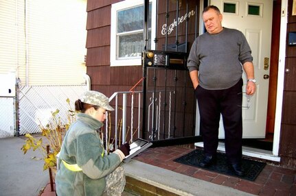 Pvt. Vanessa Diaz of the New York Army National Guard uses an electronic notebook to perform wellness checks Dec. 6, 2012, on Staten Island.