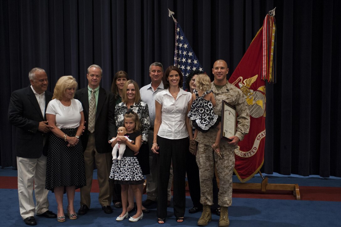 Master Sgt. Keith Martinez, U.S. Marine Drum & Bugle Corps assistant drum major, and his family take a picture just after his promotion ceremony at Marine Barracks Washington, D.C., Aug. 1.