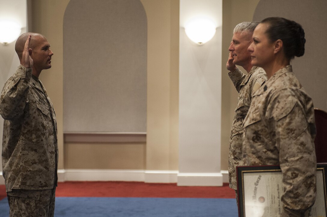 Master Sgt. Keith Martinez, U.S. Marine Drum & Bugle Corps assistant drum major, takes the oath of enlistment during his promotion ceremony at Marine Barracks Washington, D.C., Aug. 1.