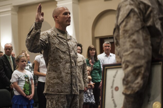 Master Sgt. Keith Martinez, U.S. Marine Drum & Bugle Corps assistant drum major, takes the oath of enlistment during his promotion ceremony at Marine Barracks Washington, D.C., Aug. 1.