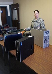 Staff Sgt. Katie Herrell sorts through computer equipment recently. Herrell is the readiness sergeant for the Missouri National Guard Computer Network Defense Team, a newly formed cyber security unit setting up shop at the historic military post in south St. Louis County.