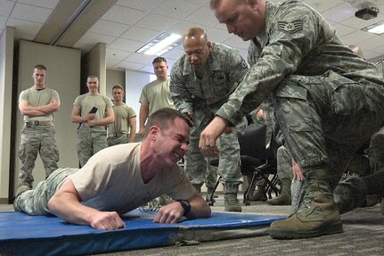 Airman 1st Class Michael Gregg reacts after receiving a shock from a Taser on Jan. 13, 2013. Gregg is a member of the 127th Security Forces Squadron at Selfridge Air National Guard Base, Mich., which has begun using Tasers as part of their patrol gear.