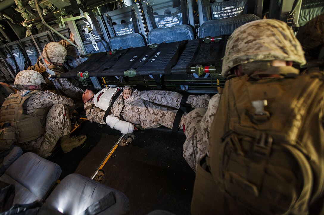 Combat Logistics Battalion 22, 22nd Marine Expeditionary Unit (MEU) Marines secure a simulated casualty’s litter into an MV-22 Osprey during a mass casualty evacuation exercise at Marine Corps Base Camp Lejeune, N.C., Aug. 7, 2013. The MEU is scheduled to deploy in early 2014 to the U.S. 5th and 6th Fleet areas of responsibility with the Bataan Amphibious Ready Group as a sea-based, expeditionary crisis response force capable of conducting amphibious missions across the full range of military operations. (U.S. Marine Corps photo by Sgt. Austin Hazard/Released)