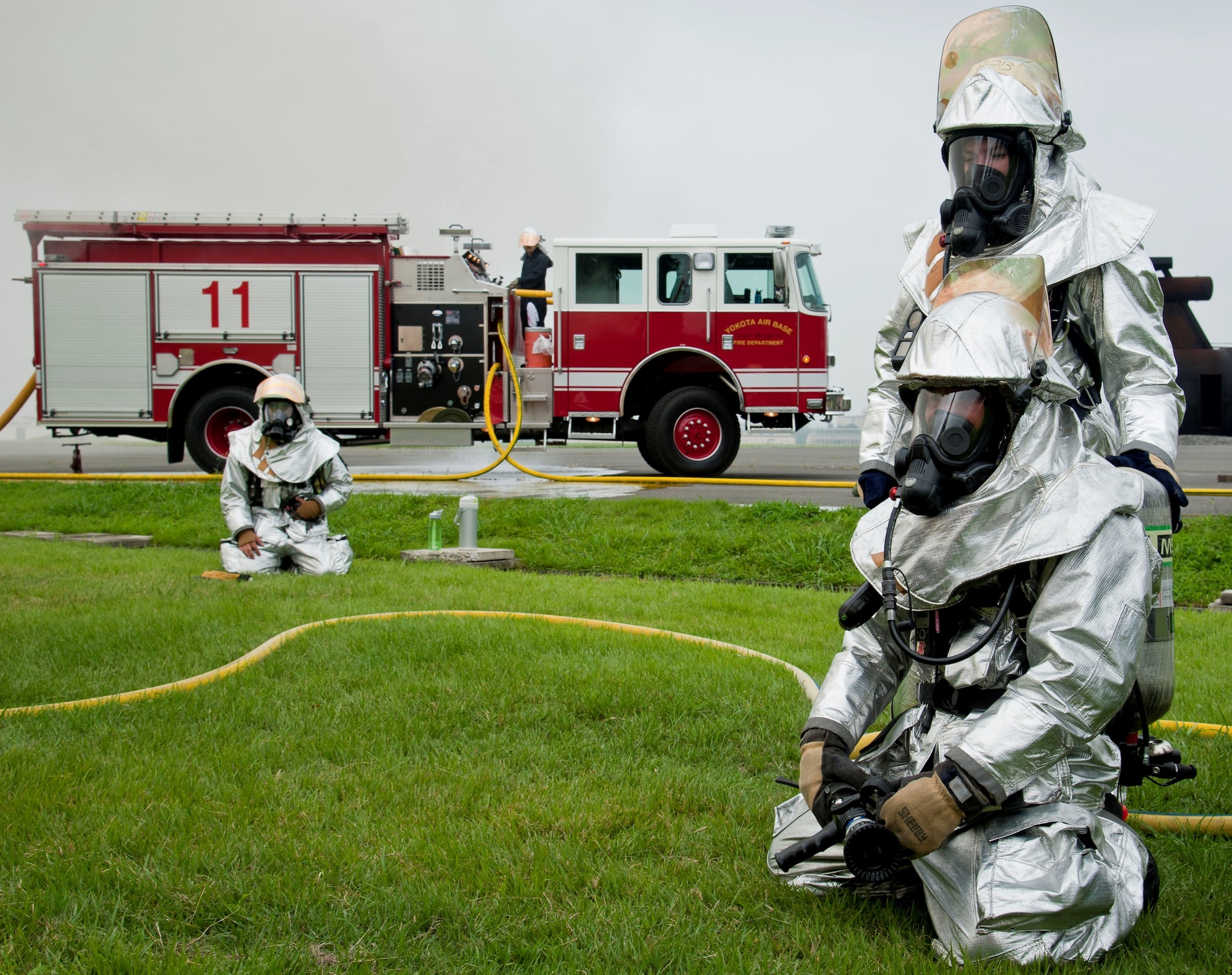 Firefighters from Yokota Air Base, Japan, standby at the simulated flashover trainer during joint training with firefighters from Marine Corps Air Station Iwakuni July 30, 2013, at Yokota AB. The training involved educating and recognizing the signs of a flashover, which is incredibly dangerous to firefighters, in a controlled training environment. (U.S. Air Force photo/Airman 1st Class Soo C. Kim) 