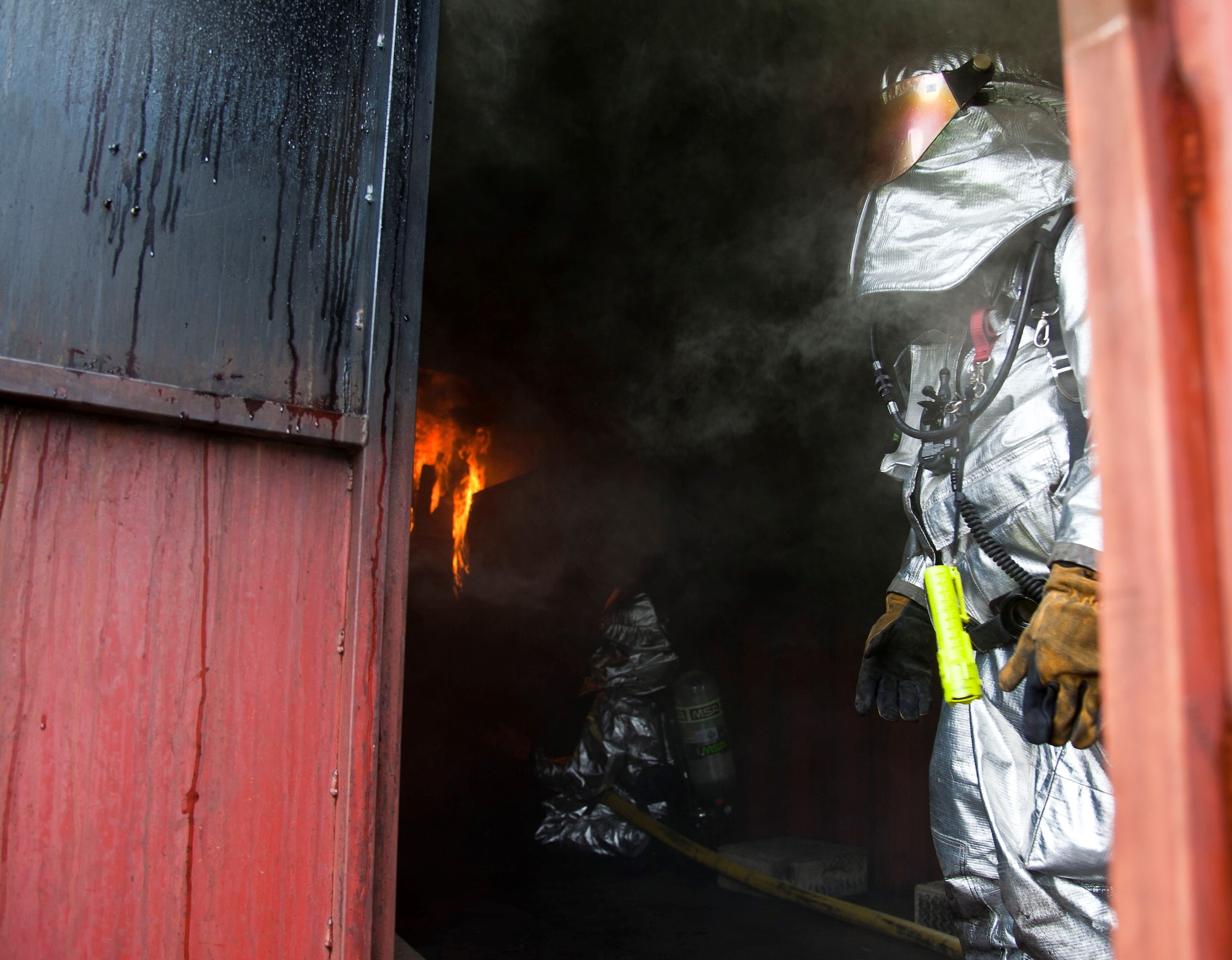 A fire burns bright inside the flashover simulator July 30, 2013, at Yokota Air Base, Japan. Marine Corps Air Station Iwakuni firefighters visited Yokota AB for joint training on recognizing and safely evading flashovers. (U.S. Air Force photo/Airman 1st Class Soo C. Kim)