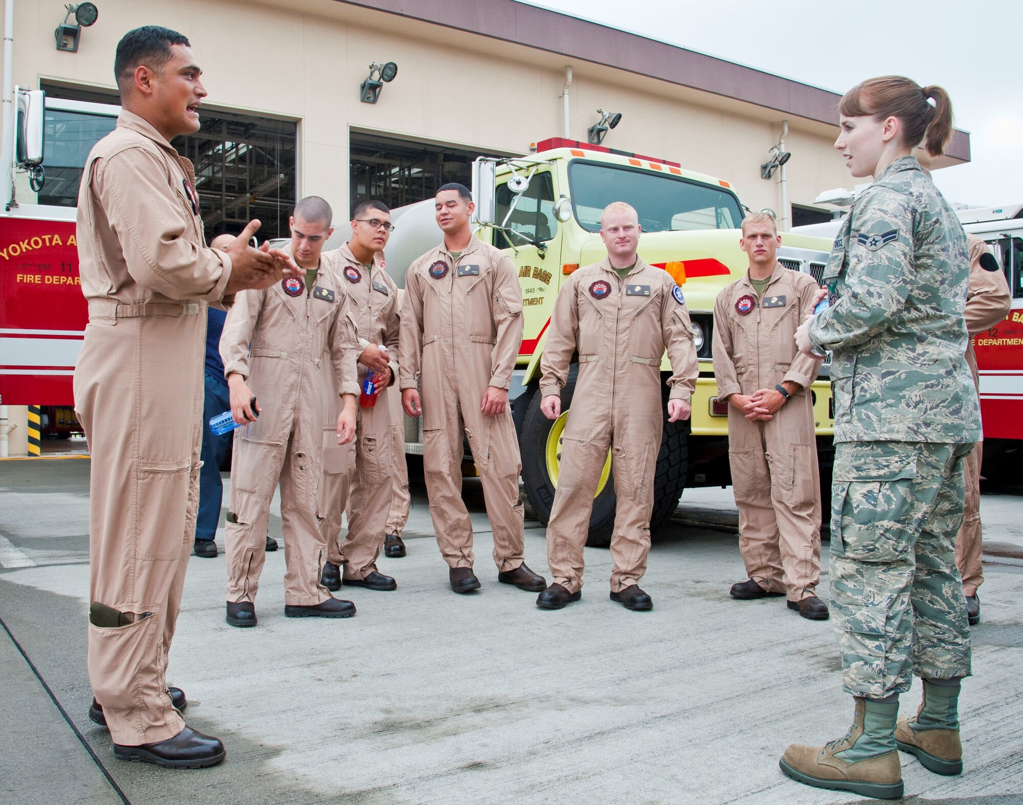 Airman 1st Class Taylor Robinett (far right), a firefighter with the 374th Civil Engineer Squadron, gives a station tour to fellow firefighters from Marine Corps Air Station Iwakuni July 30, 2013, at Yokota Air Base, Japan. Following the tour, the Marines had an opportunity to train with Airmen on responding to the dangers of flashover. (U.S. Air Force photo/Airman 1st Class Soo C. Kim) 