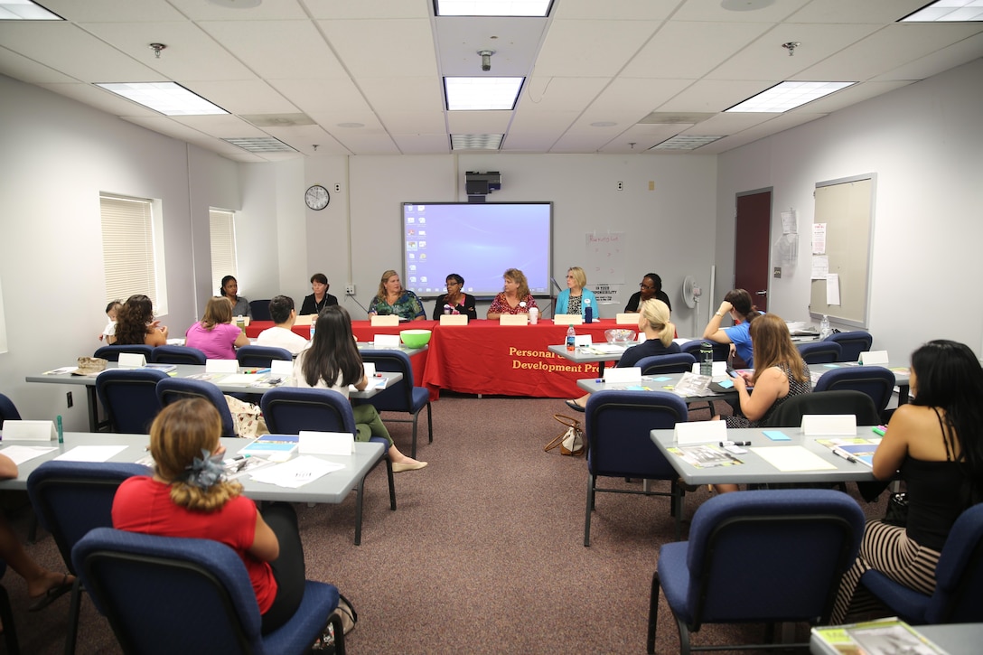 Military spouses attend a Spouse Transition and Readiness Seminar at the Jerry Marvel Training and Education Building July 31. The two-hour workshop covered a variety of topics from relocation to education and presented a panel of subject matter experts to answer questions.