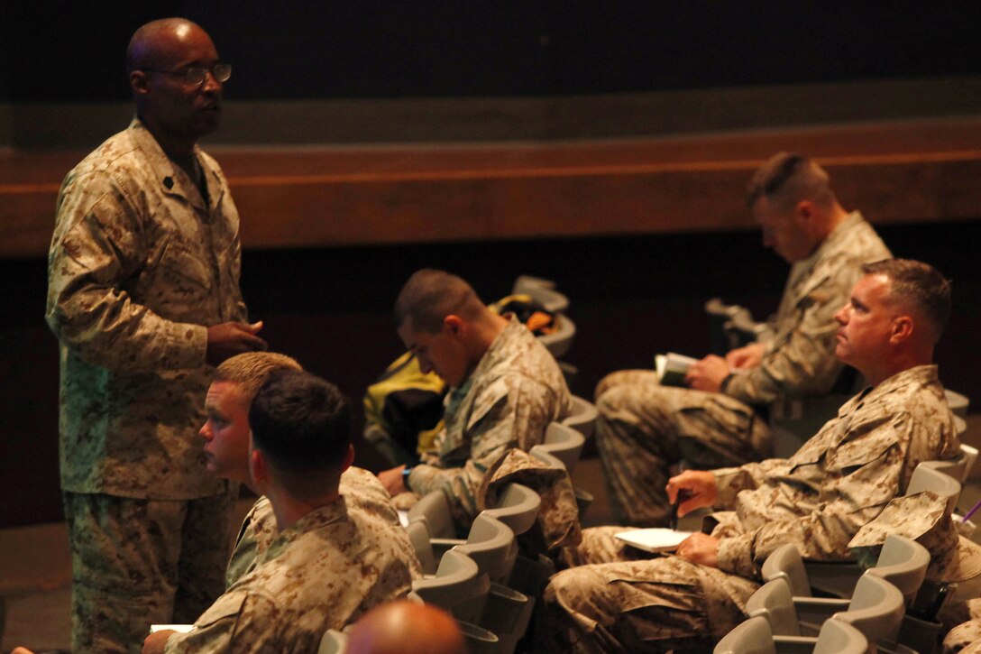 Sgt. Maj. Mark A. Byrd briefs more than 45 Marines during the Manpower Management Support Branch Promotion and Performance brief at the base theater here Aug. 7. The brief covered information to assist Reporting Seniors and Reviewing Officers with completing fitness reports, as well as help Marines receiving reports better understand how they are evaluated. Byrd is the sergeant major for the Performance Evaluation Section at Headquarter Marine Corps.
