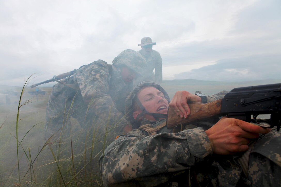 Army Reserve Officer Training Corps (ROTC) Cadet Mike Weeks drags Cadet Brian Naston as Petty Officer 3rd Class Dan Mundy supervises during a mass casualty drill, Aug 6. Approximately 1,000 service members from 13 different nations are participating in Khaan Quest 2013 in Mongolia, with a command post exercise (CPX) and field training exercise (FTX) at Five Hills Training Area in Mongolia, both focusing on peacekeeping and stability operations. U.S. Marine Corps Forces Pacific is the executive agent for this year’s exercise. Weeks, a member of the University of Notre Dame's ROTC program, is from Albuquerque, N.M. Naston, a member of University of California, Berkeley's ROTC program, is for Lancaster, Calif. Mundy, a corpsman with Kilo Company, 3rd Battalion, 3rd Marine Regiment, is from Barrington, Ill.