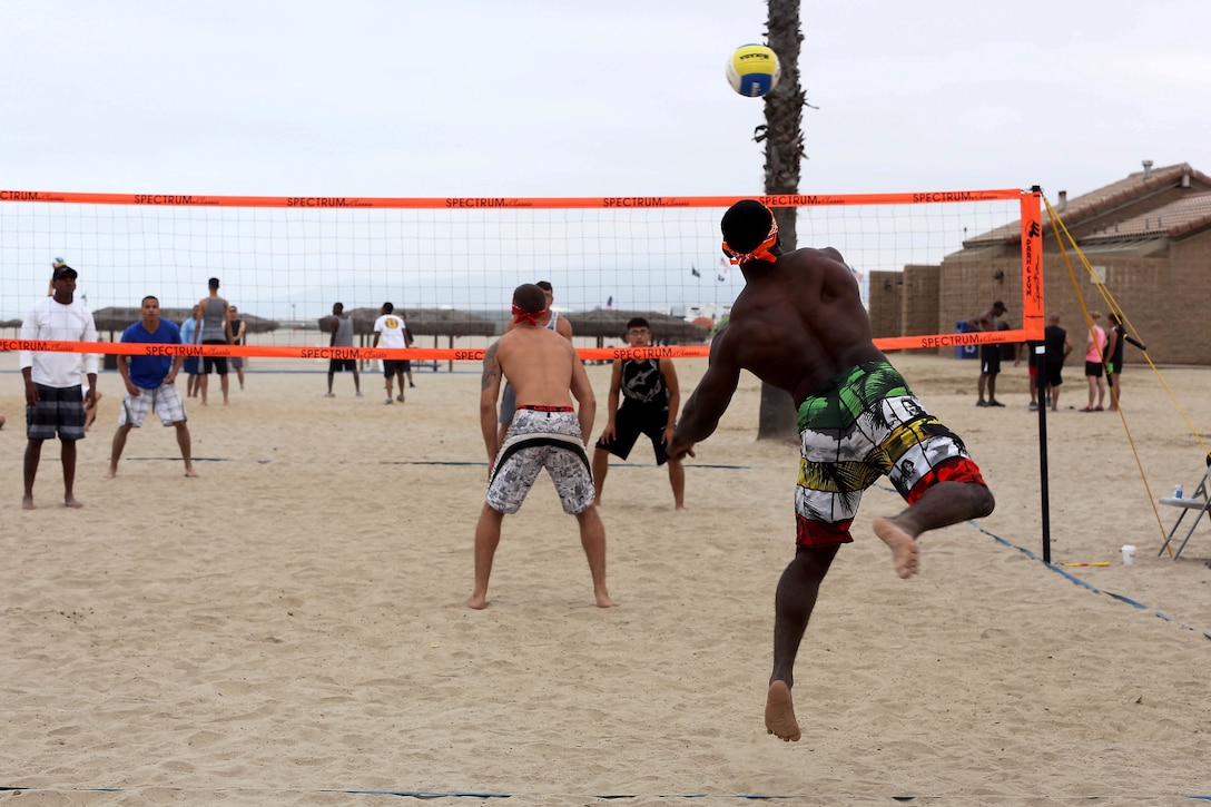 Cpl. Malcolm Jackson serves the ball during his team’s first game of the Commanding Generals Cup, Four Person Beach Volleyball Tournament held at Del Mar Beach Resort here August 7. Jackson is an intelligence analyst for 1st Intelligence Battalion here and plays on the Secret Squirrels team that took third place overall in the tournament. The tournament is an annual event and had over 120 Marines and sailors in attendance.