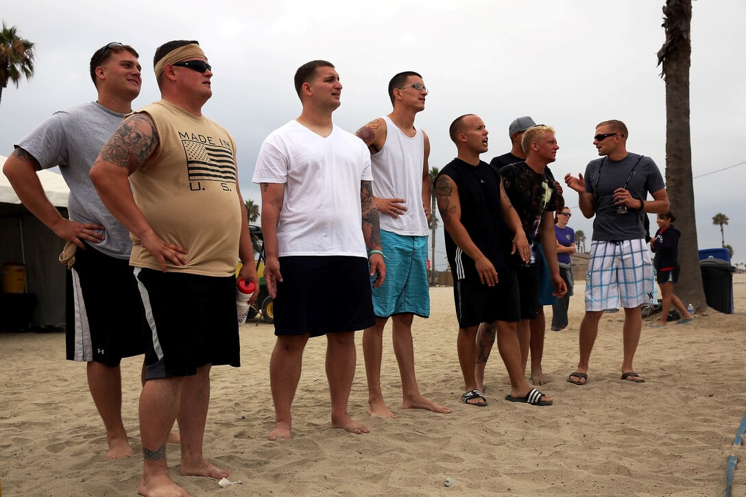 Marines from Wounded Warriors Battalion-West watch and cheer on fellow Marines during the Commanding Generals Cup, Four Person Beach Volleyball Tournament held at Del Mar Beach Resort here August 7. The tournament is an annual event and had over 120 Marines and sailors in attendance.