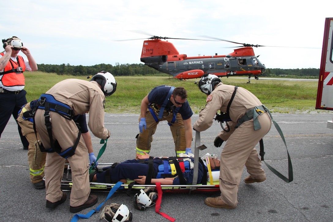 A paramedic with Fire Department 3 and Marines with Marine Transport Squadron 1 participate in Sudden Crisis 2013 Aug. 6, responding to a car crash scenario with multiple casualties. Sudden Crisis is conducted annually to evaluate Cherry Point personnel’s ability to dispatch appropriate response assets and maintain emergency responders’ ability to successfully respond to critical incidents.  