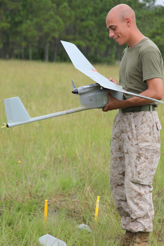 Lance Cpl. Justice C. Thomas, an intelligence analyst with 1st Battalion, 6th Marine Regiment and a native of Independence, Mo., reassembles the RQ-11B Raven after disassembling during its landing at Landing Zone Woodpecker Aug. 2. Reassembling the aircraft allows the Marines to sharpen their skills through valuable hands-on training time