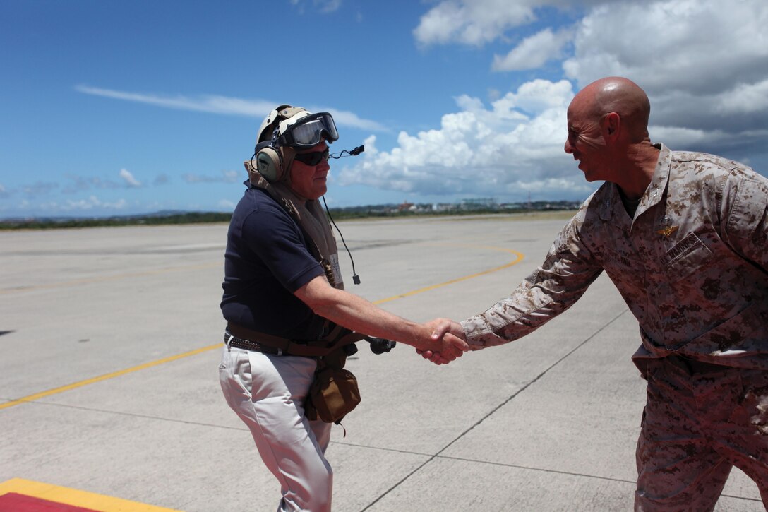 Under Secretary of Defense for Acquisition, Technology and Logistics Frank Kendall, left, is greeted by Col. James G. Flynn during Kendall’s visit to Marine Corps Air Station Futenma July 31. Kendall visited MCAS Futenma and received aerial tours of other Marine Corps installations on Okinawa to gain a better understanding of the issues associated with consolidation and realignment efforts. Flynn is the commanding officer of MCAS Futenma, Marine Corps Installations Pacific. 