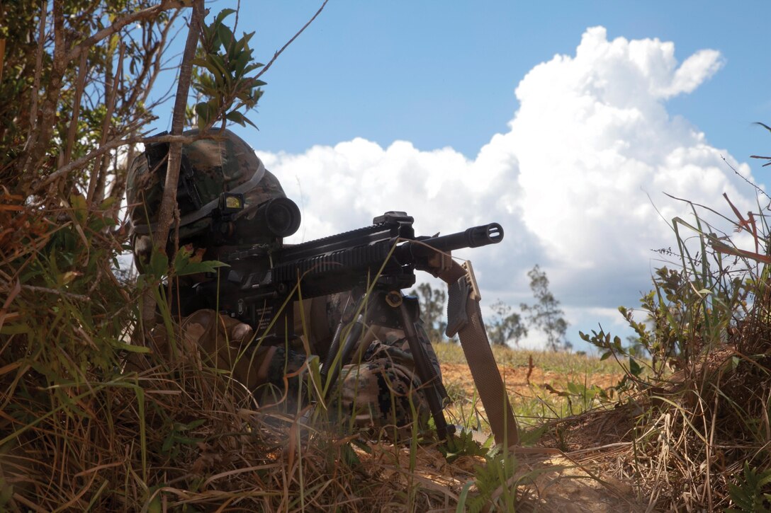 Cpl. Chris A. Fernandez provides security during a training exercise July 30 at Landing Zone Falcon in the Central Training Area. The training sharpened the Marines’ ability to gather intelligence while maintaining a secure landing zone for emergency extraction. Fernandez is a rifleman with 3rd Battalion, 3rd Marine Regiment, currently assigned to 4th Marine Regiment, 3rd Marine Division, III Marine Expeditionary Force, under the unit deployment program. photo by Lance Cpl. Natalie M. Rostran