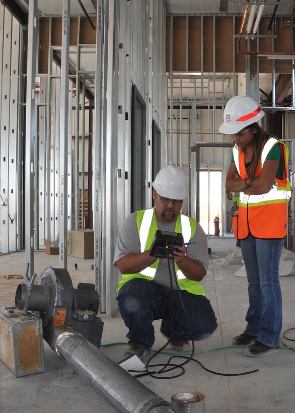 NELLIS AFB, Nev. – Janiera Caigoy, a mechanical engineer with the U.S. Army Corps of Engineers Los Angeles District's Nellis Resident Office, inspects the results of a July 30 test on the ducting at the Aerospace Ground Equipment facility being built on the Air Force Base. Caigoy and the rest of the USACE team are working several projects on the base to support the F-35 mission. 