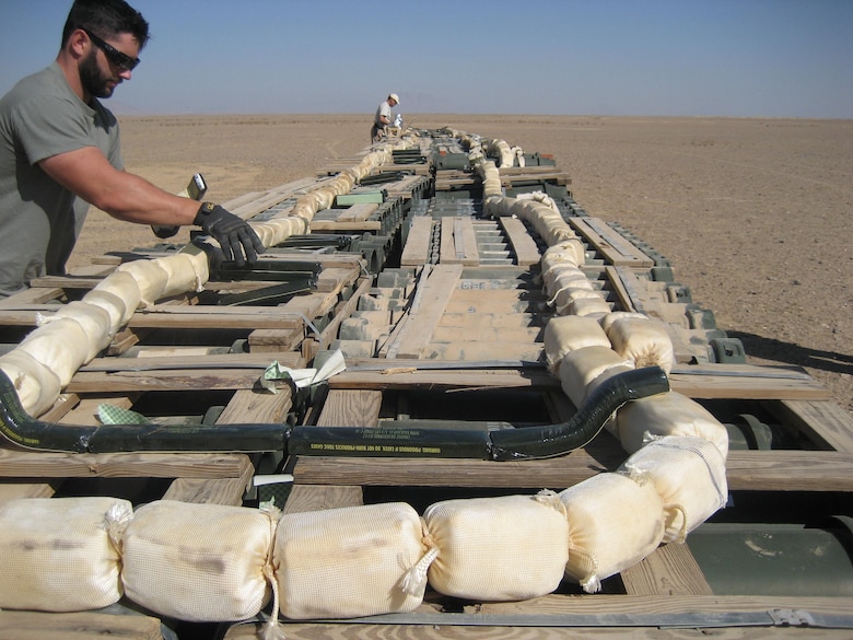 Two of EODT's senior unexploded ordnance technicians set up a large disposal 'shot' in Southwest Afghanistan using C4 and MICLIC donor charges.