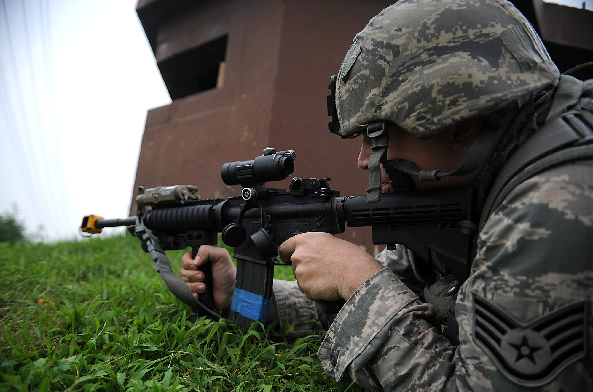Staff Sgt. Gerald  Lombardi, 51st Security Forces defender, aims at 51st SFS members acting as opposing forces during an operation readiness exercise, Beverly Midnight 13-03, at Osan Air Base, Republic of Korea, Aug. 9, 2013. Counter surveillance scenarios are conducted throughout the ORE in order to help security forces Airmen learn how to better secure the base and defend against opposing forces. (U.S. Air Force photo/Staff Sgt. Sara Csurilla)  