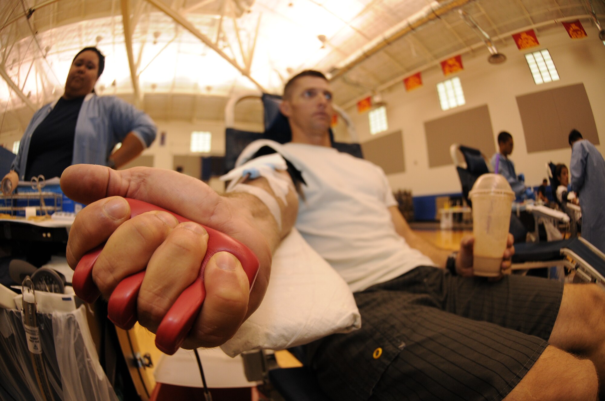 Master Sgt. Christopher Thorne, 734th Air Mobility Squadron air transportation manager, squeezes his hand to increase the blood flow through his veins at an Armed Services Blood Program blood drive Aug. 7, 2013, on Andersen Air Force Base, Guam. Guam’s ASBP Donor Center conducts a blood drive at the Coral Reef Fitness Center monthly. (U.S. Air Force photo by Airman 1st Class Emily A. Bradley/Released)