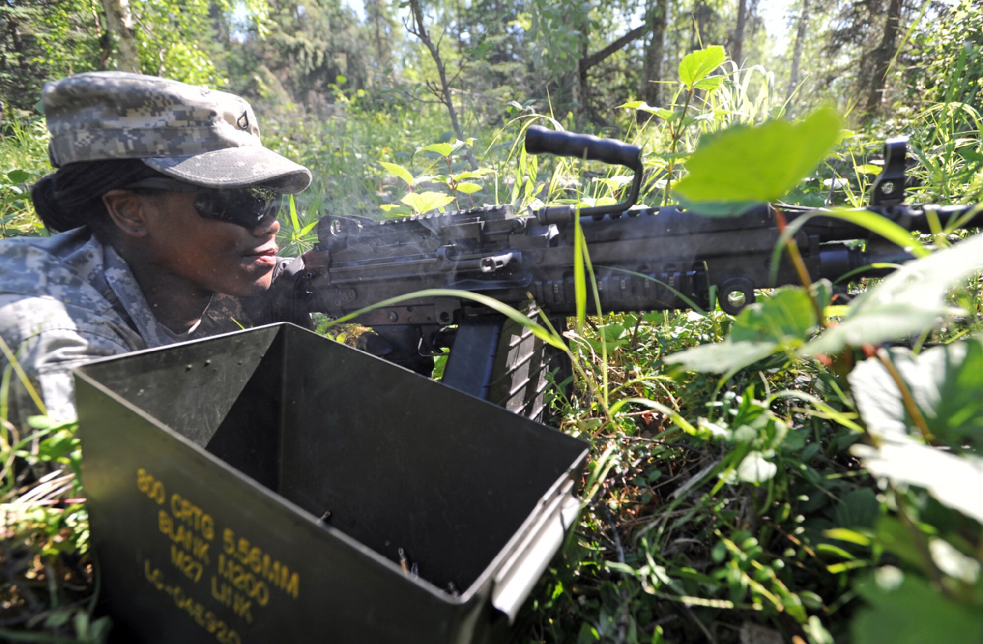JOINT BASE ELMENDORF-RICHARDSON, Alaska -- Army Pfc. Shkendra Hightower, assigned to the 164th Military Police Company, 2d Engineer Brigade, a native of Lubbock, Texas, fires an M-249 Squad Automatic Weapon as part of an Opposing Force in a situational training exercise lane during team qualifications at Joint Base Elmendorf-Richardson, Wednesday, July 24, 2013.  The military police Soldiers trained on various team-based scenarios aimed at testing their abilities to adapt to rapidly changing situations under stressful physical and mental conditions.   (U.S. Air Force photo/Justin Connaher)