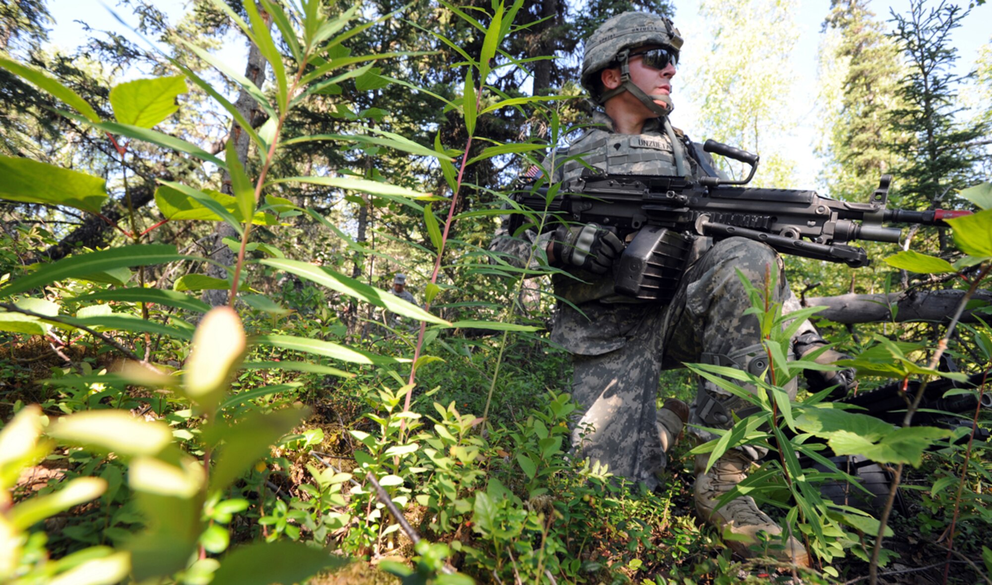 JOINT BASE ELMENDORF-RICHARDSON, Alaska -- Spc. Paul Unzueta, assigned to the 164th Military Police Company, 2d Engineer Brigade, a native of Lemoore, Calif., pulls security in a situational training exercise lane during team qualifications at Joint Base Elmendorf-Richardson, Wednesday, July 24, 2013.  The Soldiers trained on various team-based scenarios aimed at testing their abilities to adapt to rapidly changing situations under stressful physical and mental conditions.   (U.S. Air Force photo/Justin Connaher)