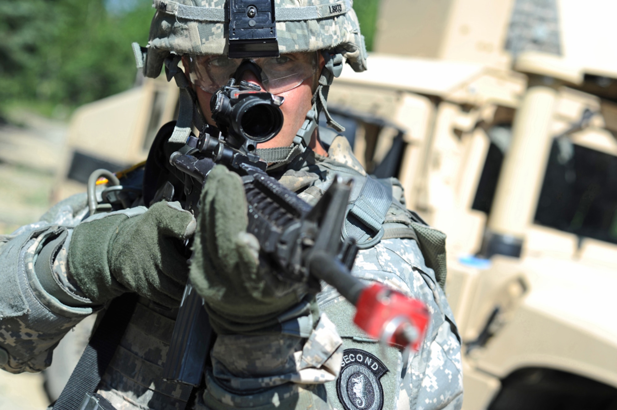 JOINT BASE ELMENDORF-RICHARDSON, Alaska -- Army Pfc. Eric Leow, a native of Laingsburg, Mich., assigned to the 164th Military Police Company, 2d Engineer Brigade, provides security at a suspected improvised explosive devise location in a situational training exercise lane during team qualifications at Joint Base Elmendorf-Richardson, Wednesday, July 24, 2013.  The military police Soldiers trained on various team-based scenarios aimed at testing their abilities to adapt to rapidly changing situations under stressful physical and mental conditions.   (U.S. Air Force photo/Justin Connaher)