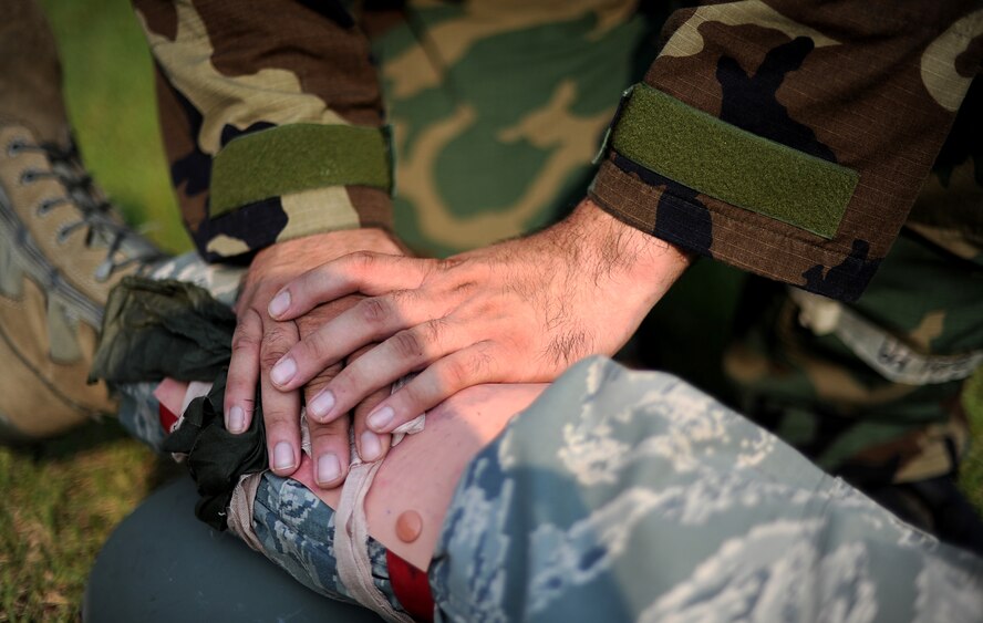 An Airman from the 51st Fighter Wing holds pressure onto a simulated wound after a training scenario during Operational Readiness Exercise Beverly Midnight 13-03, Aug. 8, 2013. The scenario was held in order to help Airmen practice Self Aid Buddy Care techniques. Airmen perfect these types of skills during OREs to prepare for possible contingency operations.  (U.S. Air Force photo/Staff Sgt. Sara Csurilla)