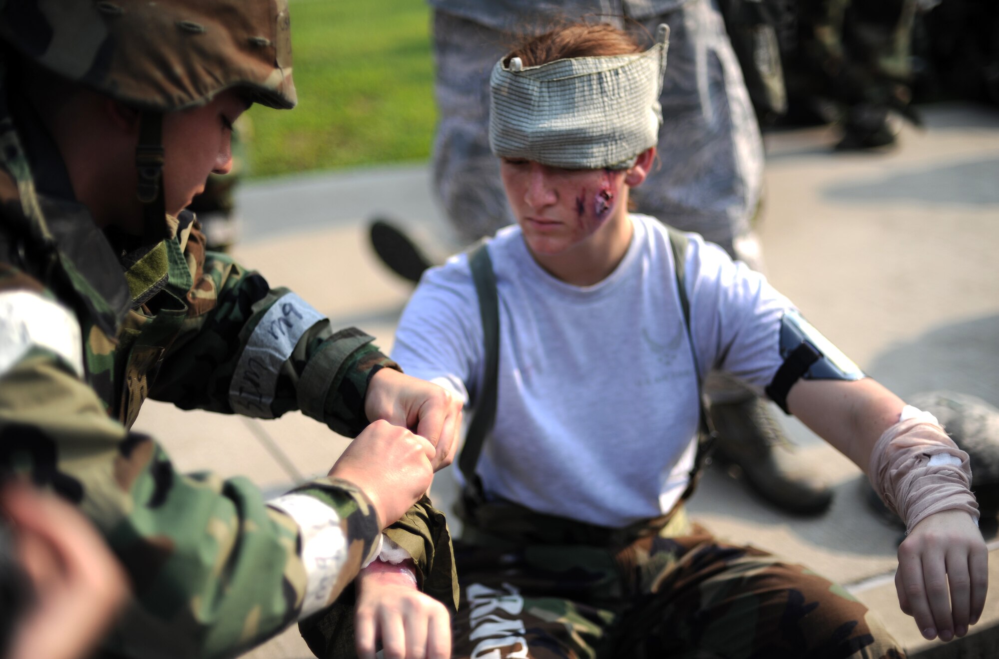 Airman 1st Class Hallie Zdanczewski, a medical technician with the 51st Medical Group, has her wounds dressed after being injured in a simulated missile attack during Operational Readiness Exercise Beverly Midnight 13-03, Aug. 8, 2013. These exercises tests Osan Airmen’s abilities during a heightened state of readiness while providing combat ready forces for close air support, air strike control, counter air, interdiction, theater airlift and communications in the defense of the ROK. (U.S. Air Force photo/Staff Sgt. Sara Csurilla)