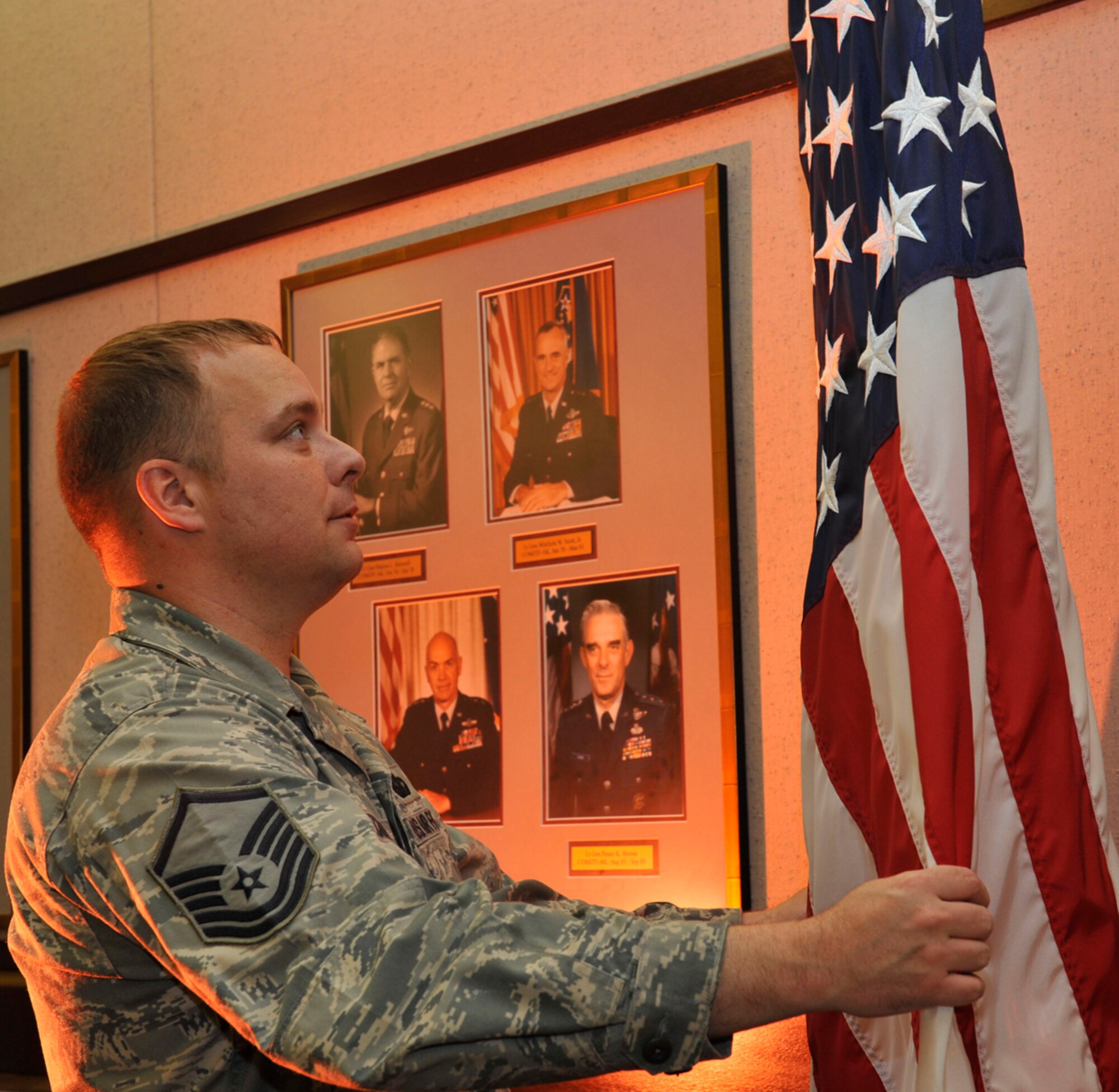 Air Force Master Sgt. Richard Bechand, 11th Air Force Protocol superintendent, fixes the U.S. flag for a presentation at Joint Base Elmendorf-Richardson, Alaska, Aug. 3, 2013. Bechand was awarded the first-ever Pacific Air Forces Protocol Professional of the Quarter award during a ceremony at Alaska Command Headquarters on Joint Base Elmendorf-Richardson June 7. The award recognizes outstanding professionalism and excellence in the protocol career field. Protocol Airmen perform a wide range of duties such as ensuring base events adhere to proper Air Force customs to and courtesies. (U.S. Air Force photo/Airman 1st Class Tammie Ramsouer)