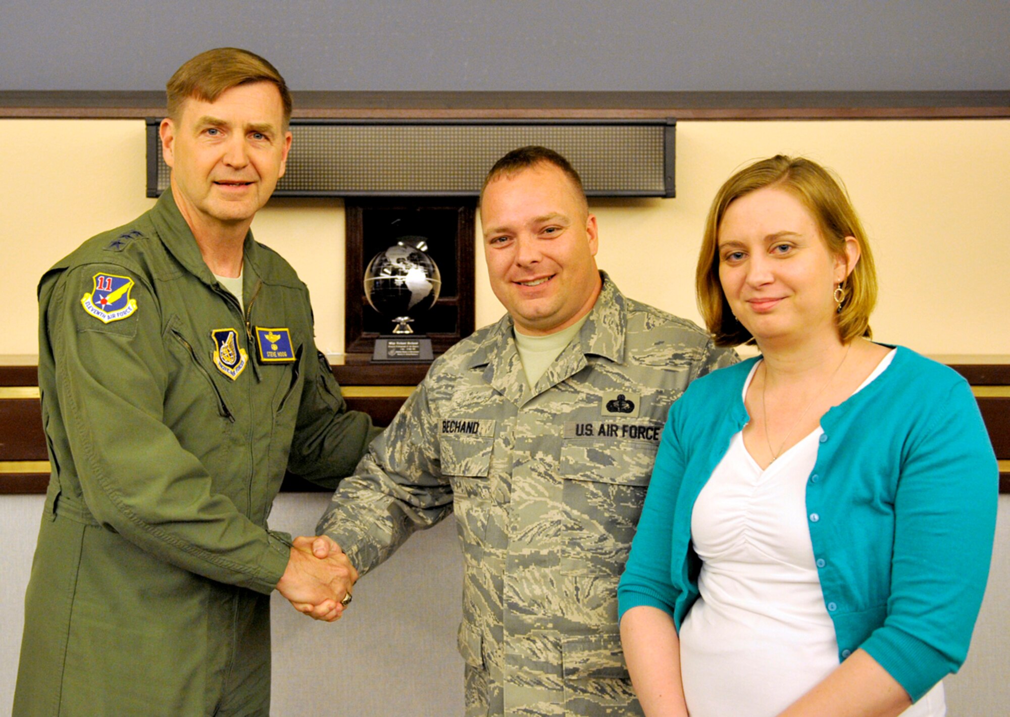 Air Force Maser Sgt. Richard Bechand, 11th Air Force superintendent of Protocol, is awarded the first ever Pacific Air Force Protocol Professional of the Quarter award by Lt. Gen. Stephen Hoog, 11th Air Force commander, at Alaska Command Headquarters on Joint Base Elmendorf-Richardson June 7. Bechand recieved this award for his hard work and determination as the superintendent of Protocol. Bechand's job is to make events on base run as smoothly as possible and to enforce proper customs and courtesies at events, such as change-of-command ceremonies. (U.S. Air Force photo/Airman 1st Class Tammie Ramsouer)