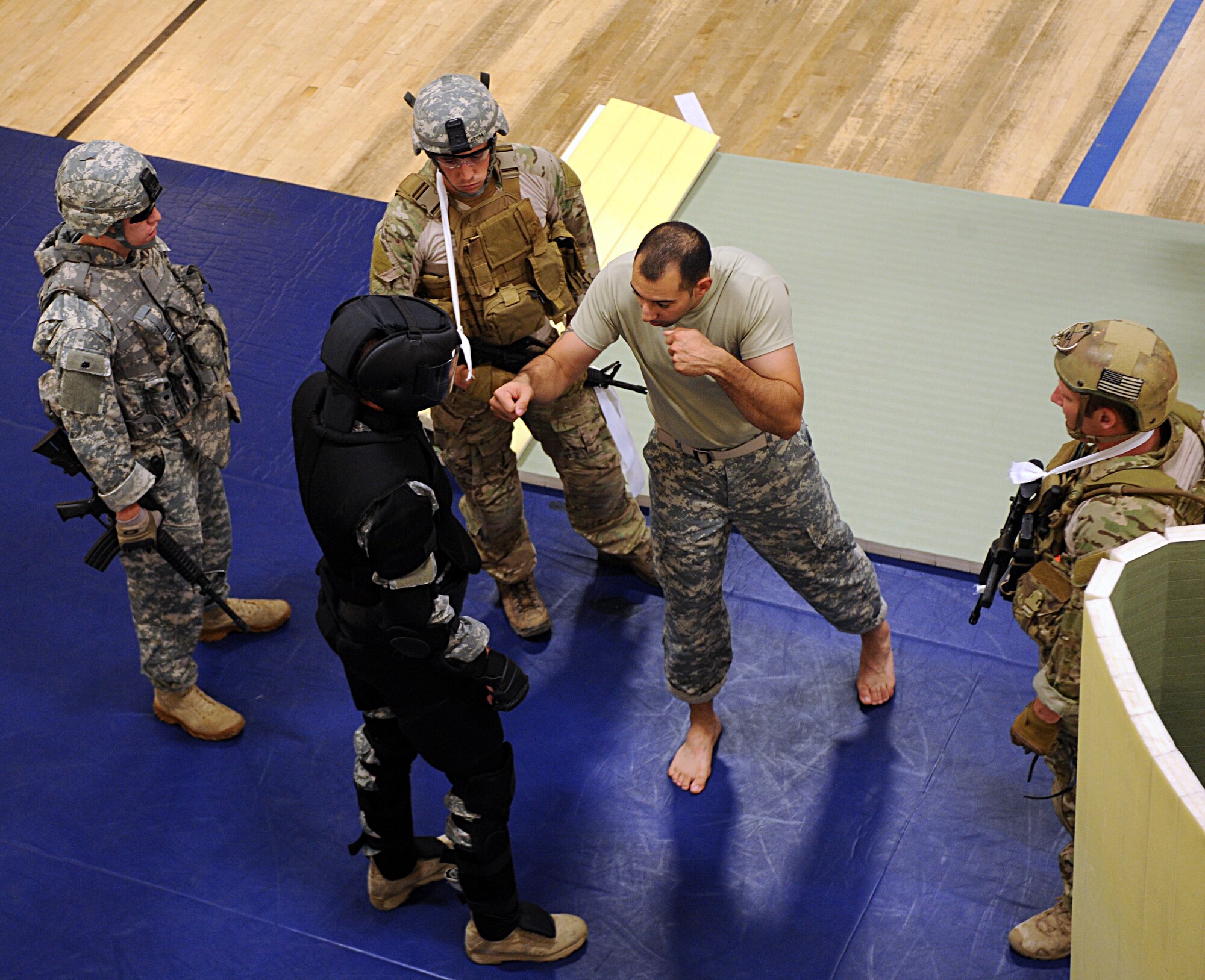 U.S. Army Staff Sgt. Parris Bussiere, 1st Battlefield Coordination Detachment tactical combatives instructor, explains one of the basic strikes taught in the U.S. Army Basic Combatives Course at Davis-Monthan Air Force Base, Ariz., July 25, 2013. The course is available to service members from all branches of the armed forces, whether they are active duty, reservist, guard or retiree. (U.S. Air Force photo by Senior Airman Timothy Moore/Released)