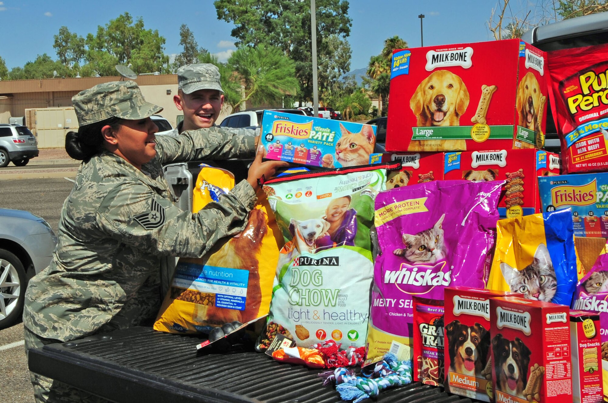 U.S. Air Force Tech. Sgt. Michelle Klemisch, 355th Force Support Squadron noncommissioned officer in charge of career development, and Senior Airmen Garrett Dow, 355th FSS Career Development technician, load a truck with donations at Davis-Monthan Air Force Base, Ariz., Aug. 8, 2013. The donations will be dropped off at a local shelter at the end of August. (U.S. Air Force Photo by Senior Airman Camilla Elizeu/Released)