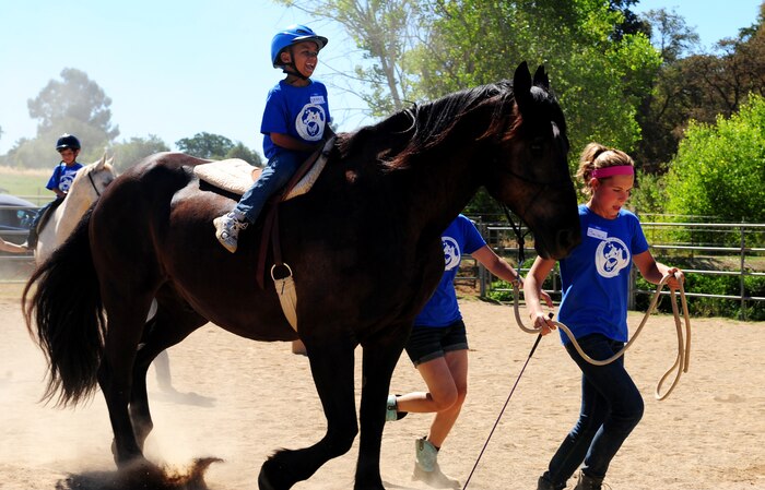 Daniel Matlack rides Dulce at Batti Ranch in Lincoln, Calif., on Aug. 2, 2013. Batti Ranch hosts a number of programs for Beale Airmen and their families. (U.S. Air Force photo by Airman 1st Class Bobby Cummings/Released)
