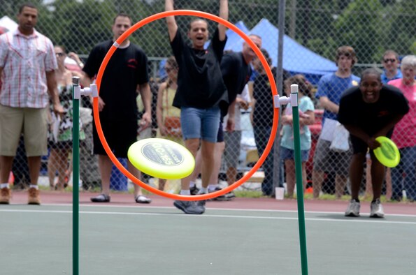 Master Sgt. Cynthia Anderson, 94th Aeromediical Staging Squadron laboratory technician, lands a frisbee through the hoop during a fire muster at the 94th Airlift Wing Family Day at the Dobbins Lakeside Facility Aug. 4. The four member team from 94th ASTS took home the first place trophey (U.S. Air Force photo/Don Peek)