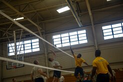 An Airman from the 437th Aerial Port Squadron jumps to spike volleyball against Navy Sailors during a match Aug. 2, 2013, at the Fitness Center on Joint Base Charleston, S.C. (U.S, Air Force photo/Tech. Sgt. Douglas)