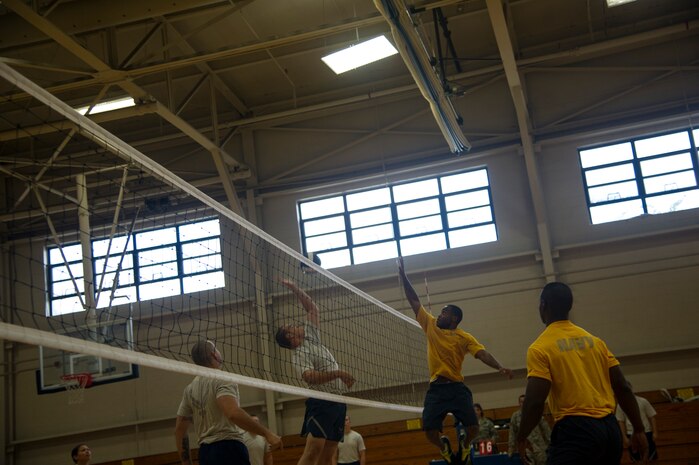 An Airman from the 437th Aerial Port Squadron jumps to spike volleyball against Navy Sailors during a match Aug. 2, 2013, at the Fitness Center on Joint Base Charleston, S.C. (U.S, Air Force photo/Tech. Sgt. Douglas)