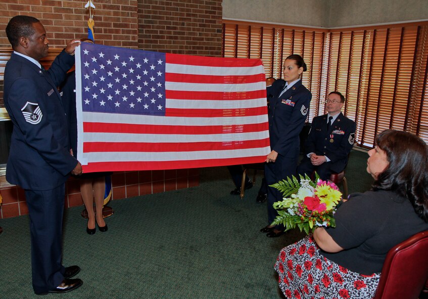 Members of the 932nd Aeromedical Staging Squadron honor guard perfom the time honored Folding of the Flag Ceremony during Master Sgt. Carlos Rosado's retirment ceremony.  (U.S Air Force photo by Tech. Sgt. Christopher Parr)