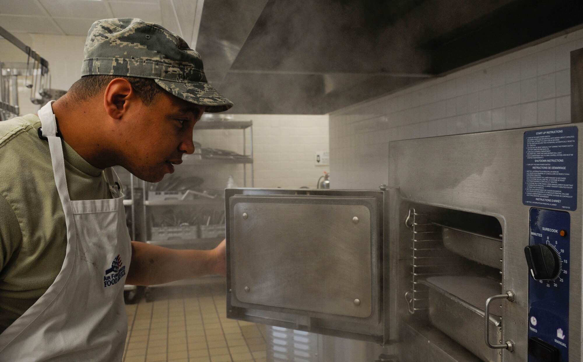 Airman 1st Class William Proemsey, 2nd Force Support Squadron food operations apprentice, checks on food items at the Red River Dining Facility on Barksdale Air Force Base, La., Aug. 8, 2013. As dining times change, food service Airmen immediately begin preparations for the next shift by preparing ingredients and cleaning the facility to ensure incoming Airmen are served in a timely and efficient manner. (U.S. Air Force photo/Airman 1st Class Andrew Moua)