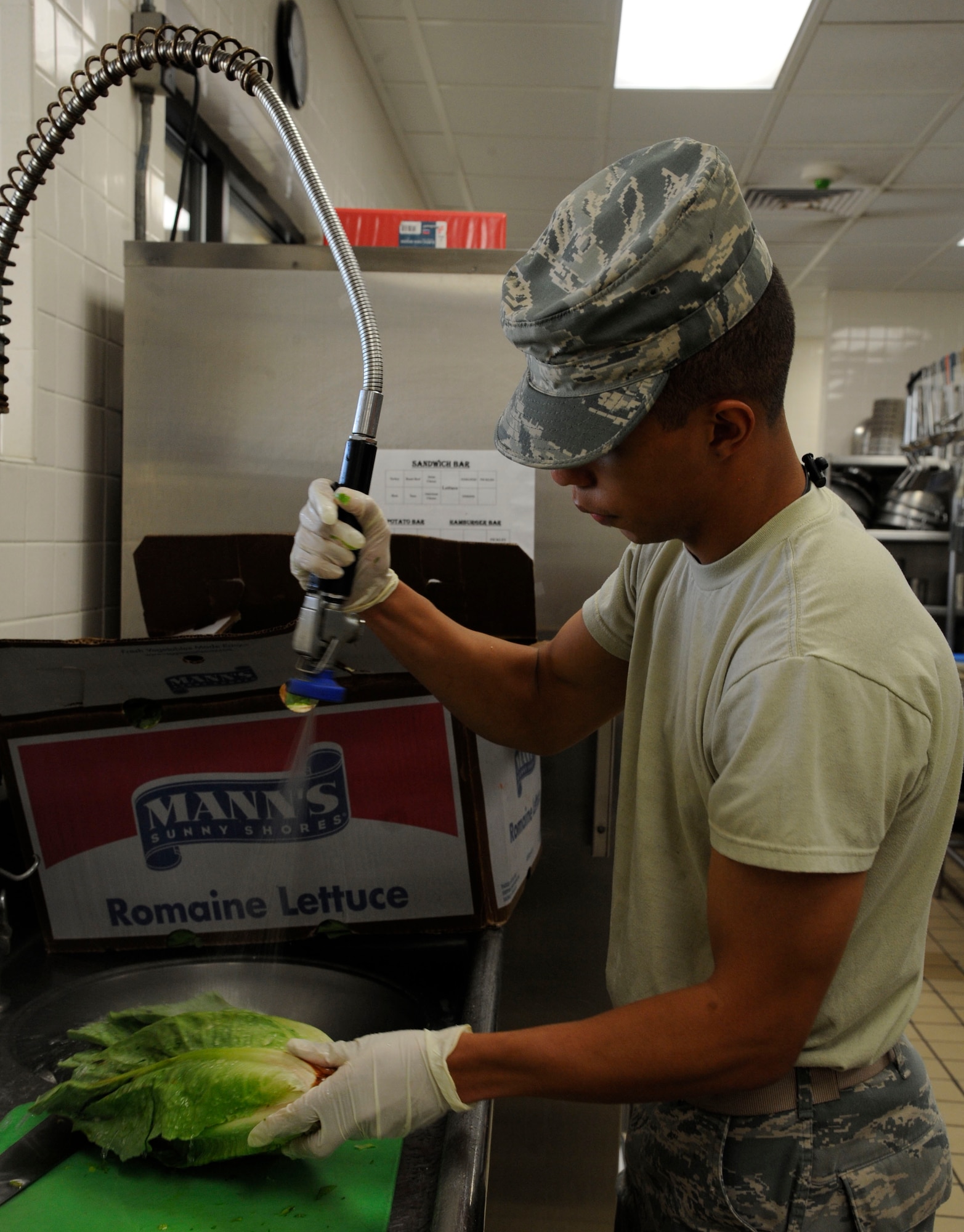 Airman 1st Class Xavier Cunningham, 2nd Force Support Squadron food operations apprentice, washes lettuce at the Red River Dining Facility on Barksdale Air Force Base, La., Aug. 8, 2013. The DFAC offers a variety of food for Barksdale Airmen ranging from a salad bar, entree line and snack bar. (U.S. Air Force photo/Airman 1st Class Andrew Moua)
