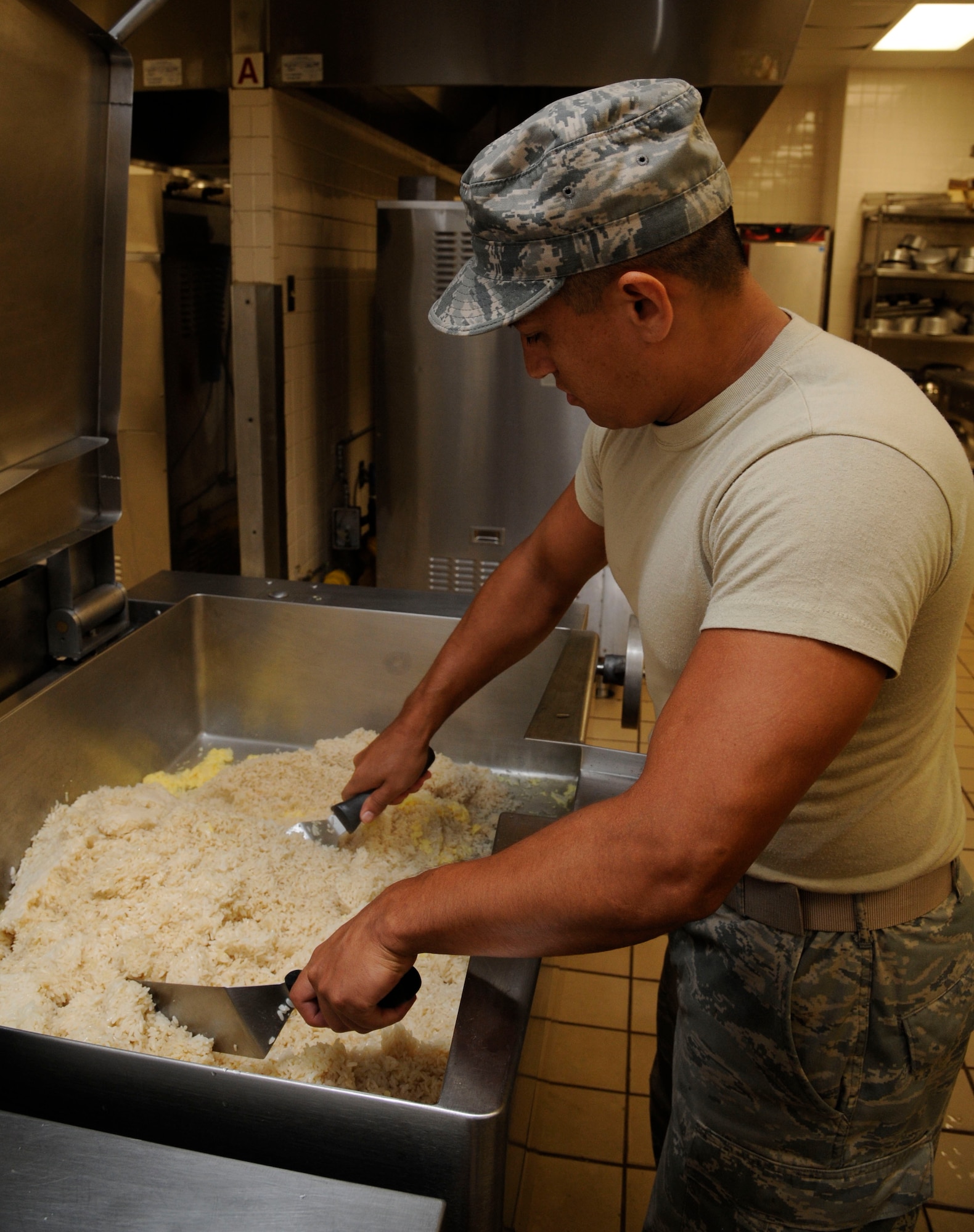 Senior Airman Jose Ortiz, 2nd Force Support Squadron food operations journeyman, cooks fried rice at the Red River Dining Facility on Barksdale Air Force Base, La., Aug. 8, 2013. Food service Airmen work every day, including holidays, to keep Barksdale Airmen, their dependents, civilian workers, and on-duty contractor personnel fed. (U.S. Air Force photo/Airman 1st Class Andrew Moua)
