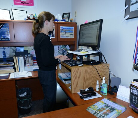 Jacqueline Maillet, 341st Medical Operations Squadron Health and Wellness Center dietician, works at her computer at the HAWC on July 30. Maillet started standing at her desk following a hamstring injury seven years ago and has been doing so ever since. (U.S. Air Force photo/Senior Airman Katrina Heikkinen)